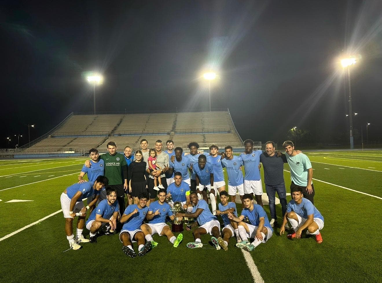 Dade County FC celebrating the 2024 USSL championship under the floodlights